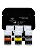 Collection of coffee packages with 'The Perla Journey' branding on a black background